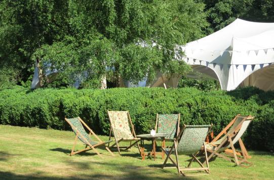 Quirky marquee and deck chairs at a wedding